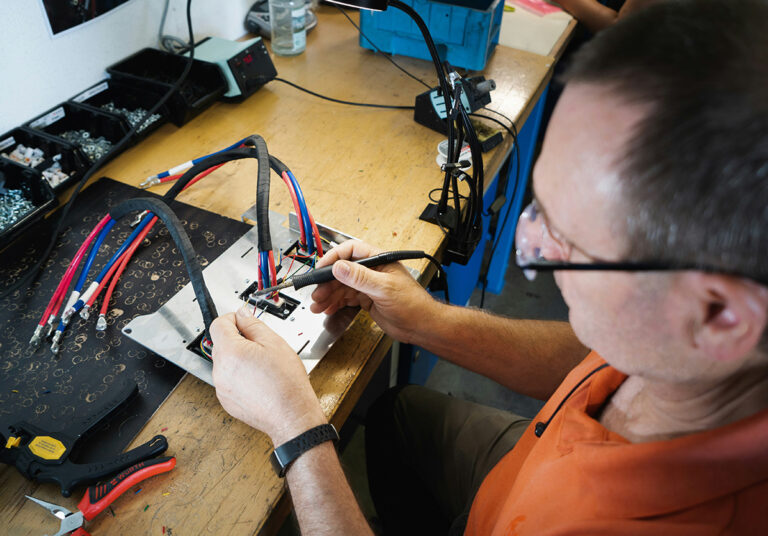 A man is repairing a laptop