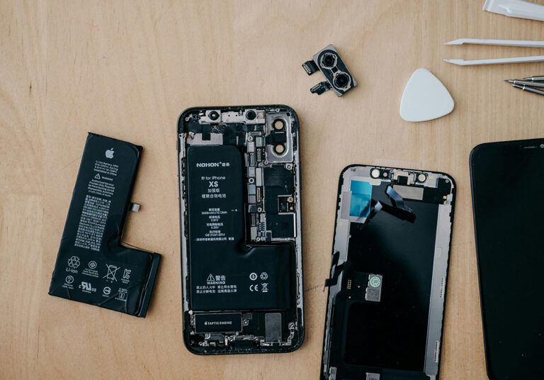 the backside of an open cellphone exposing the electronics inside ready for repair