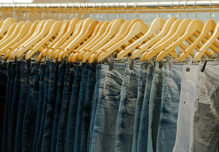 denim pants are hanged on a rack